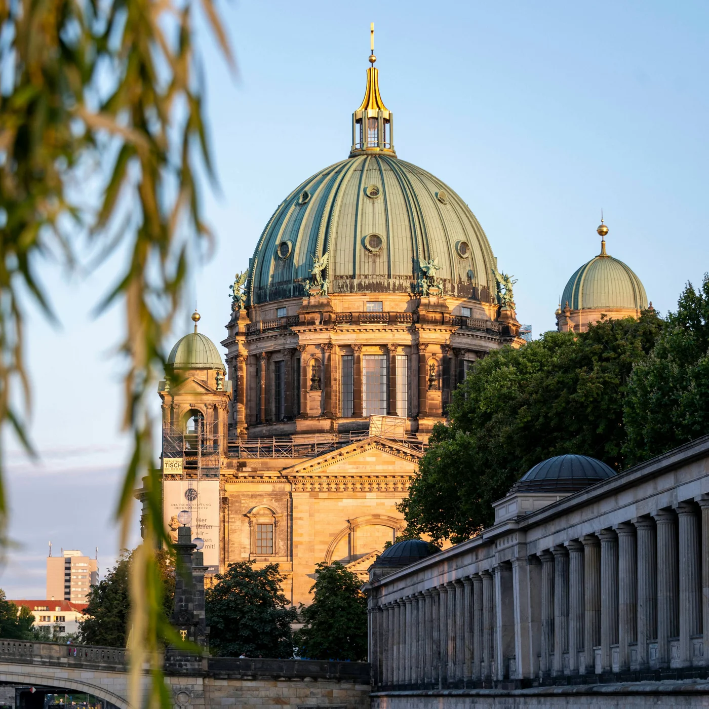 Berliner Sehenswürdigkeiten Berliner Dom mit Flussufer und blauem Himmel im Abendlicht