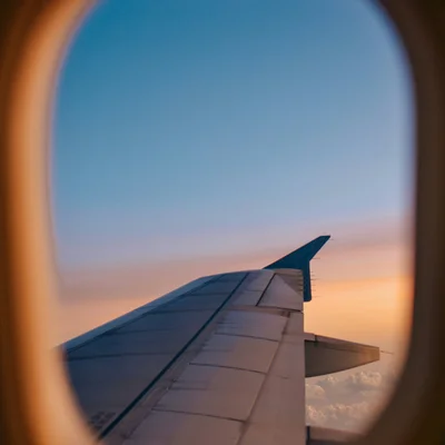 DASEYN: Kontakt und Anreise Blick aus dem Flugzeugfenster auf Tragfläche bei Sonnenuntergang